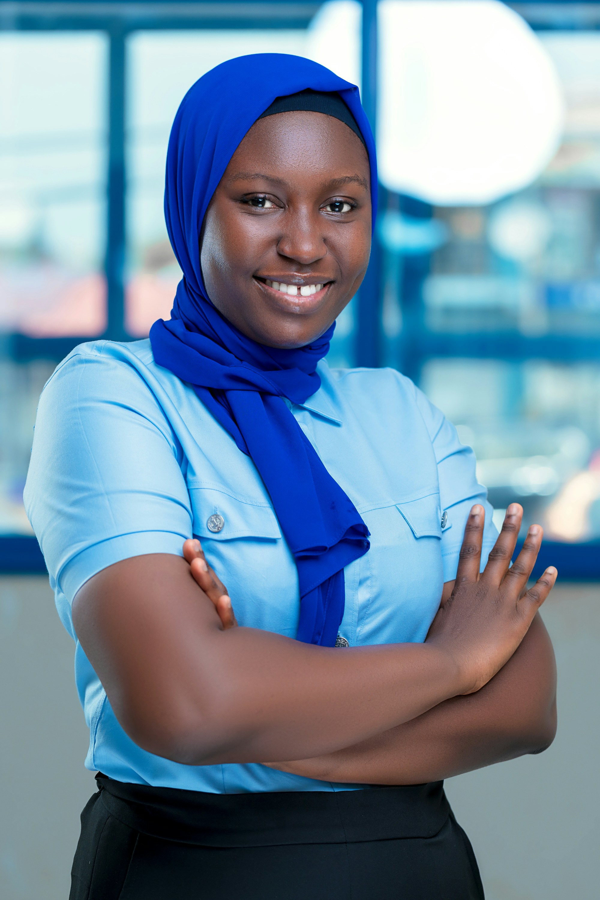 An African lady wearing an hijab and smiling